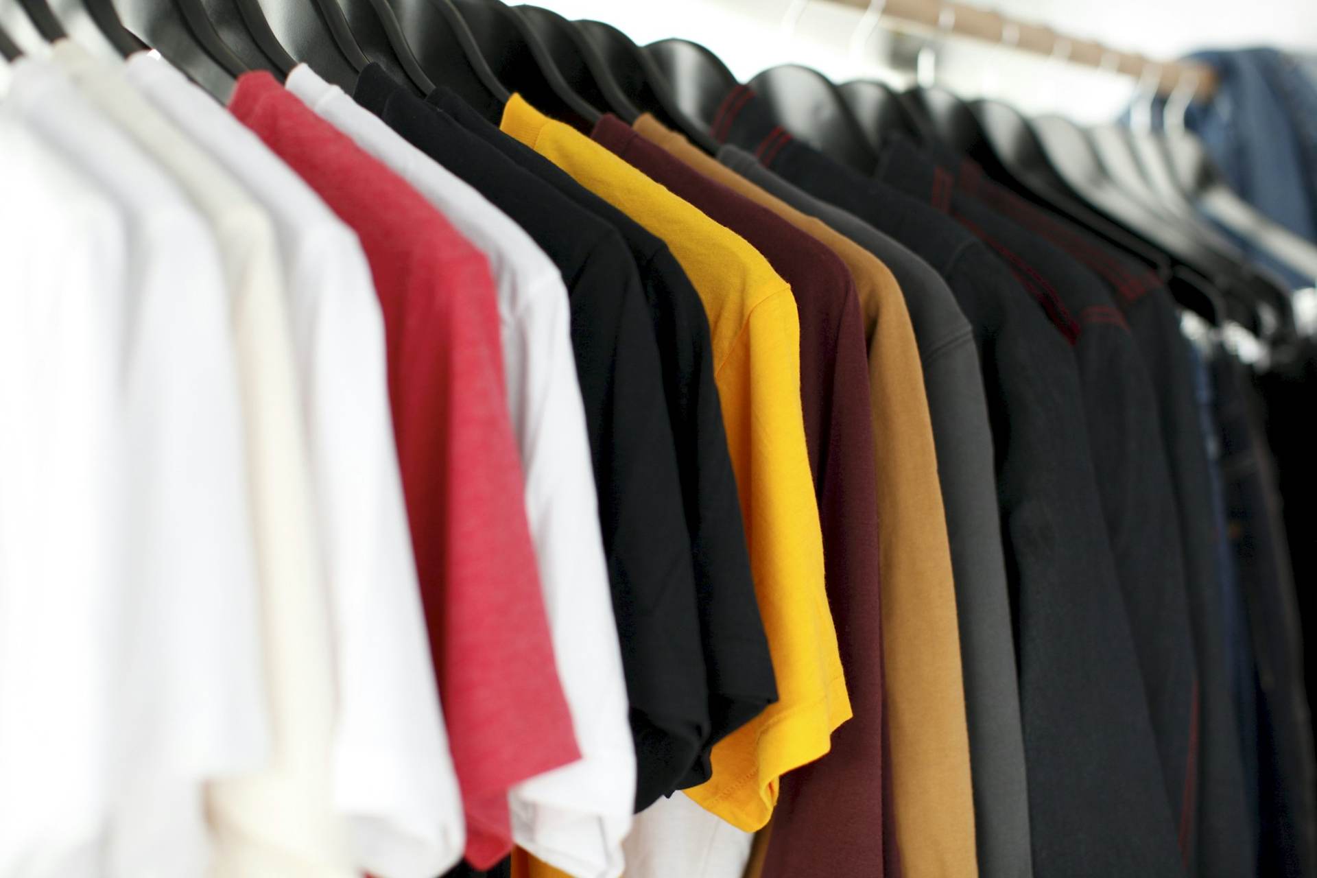 Rack of colourful t-shirts and hoodies