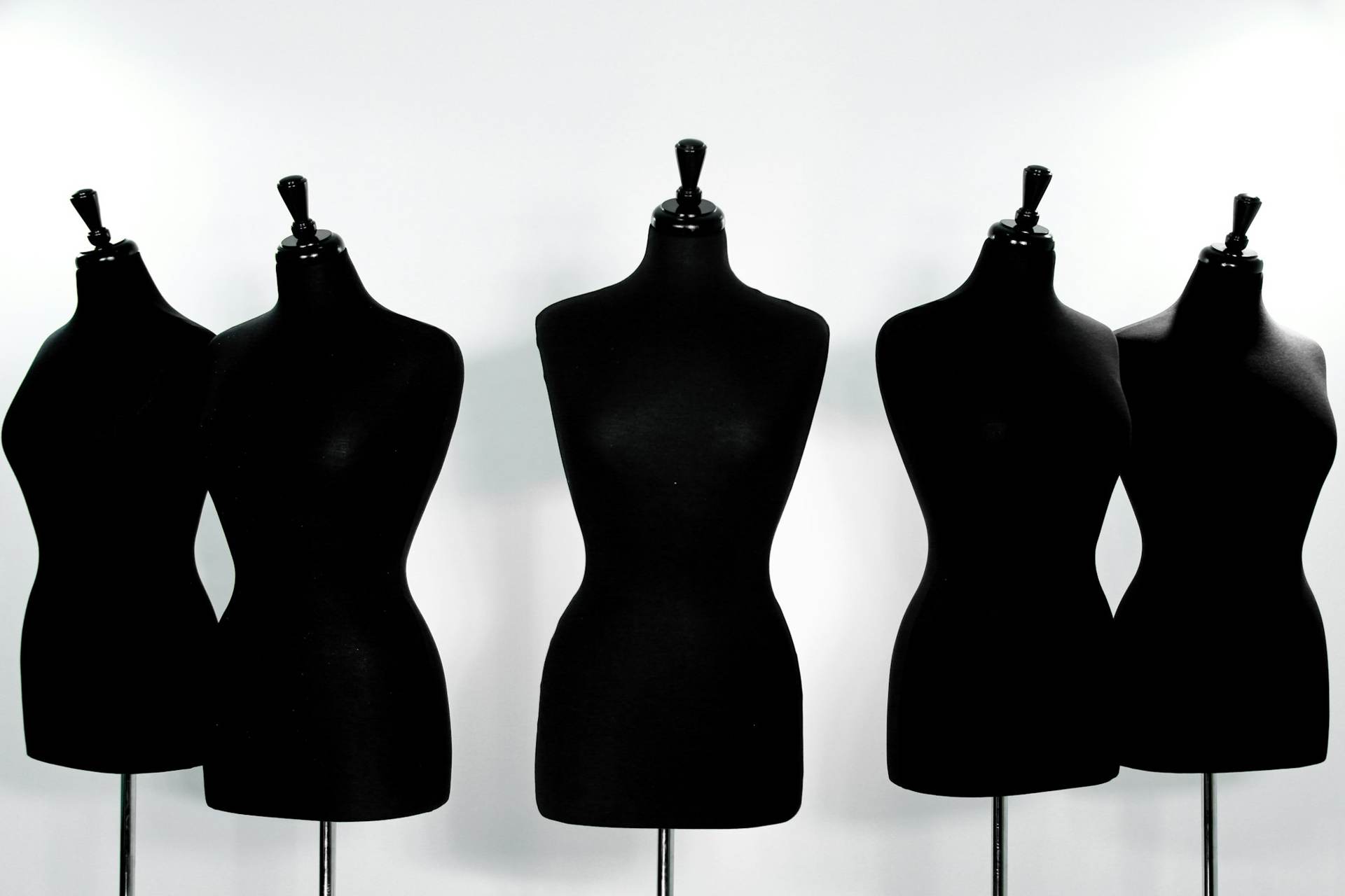 Row of black dress forms