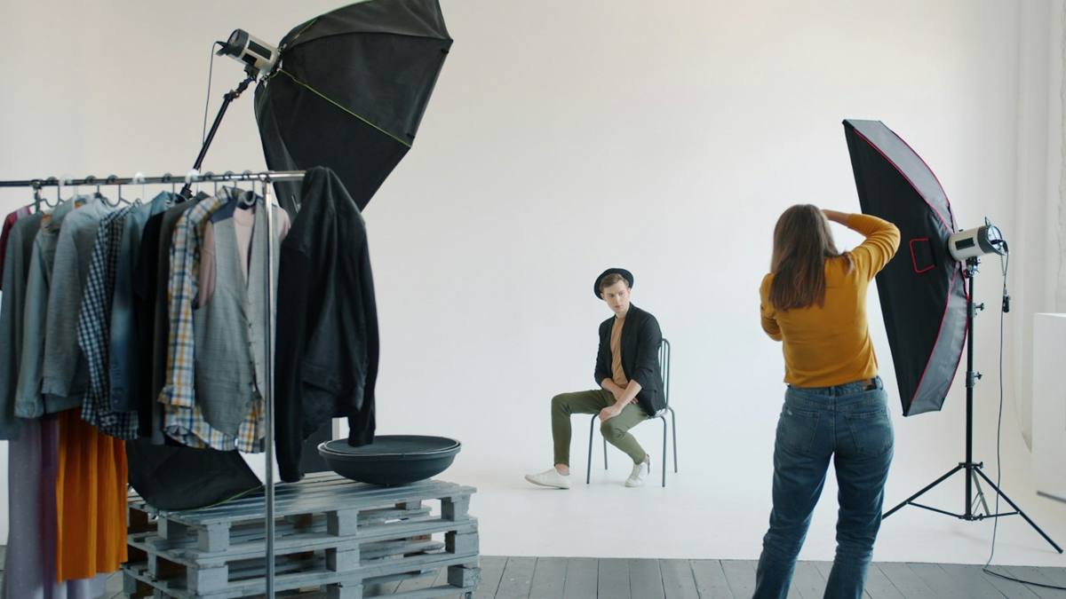 Photographer shooting a clothing collection in a studio