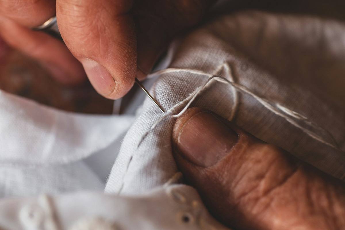 Hand stitching a seam with needle and thread
