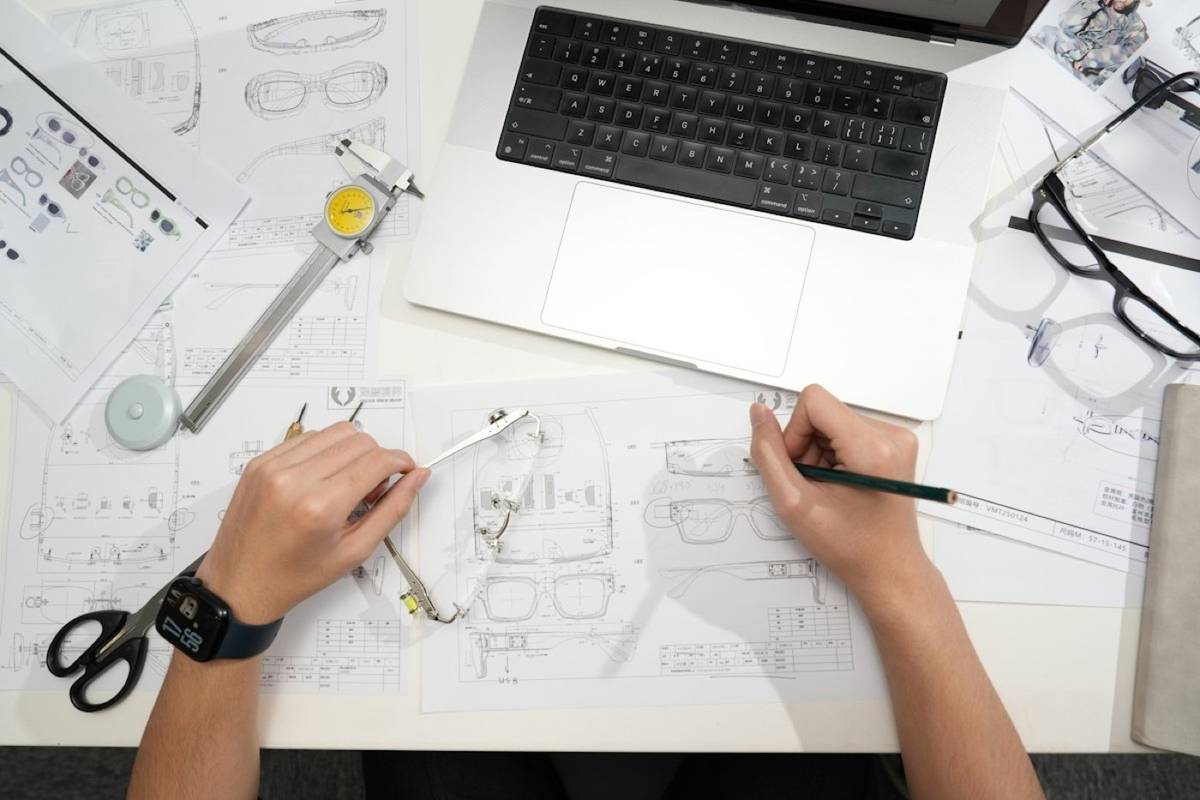 Laptop and fashion sketches on a desk